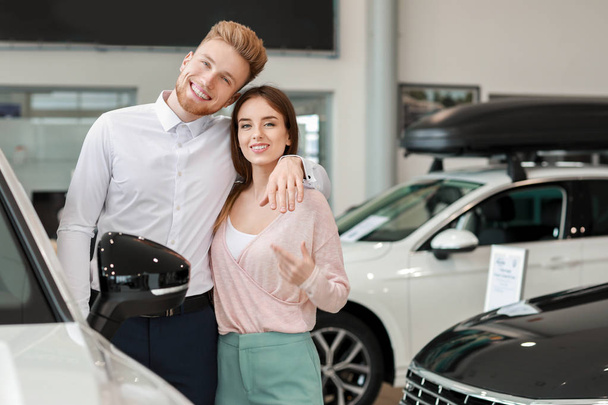 Szczęśliwa para wybiera nowy samochód w salonie - Zdjęcie, obraz