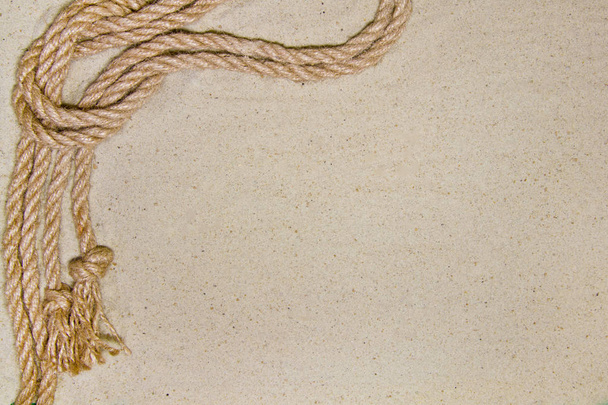 rope on sand as background top view with place for text - Foto, afbeelding