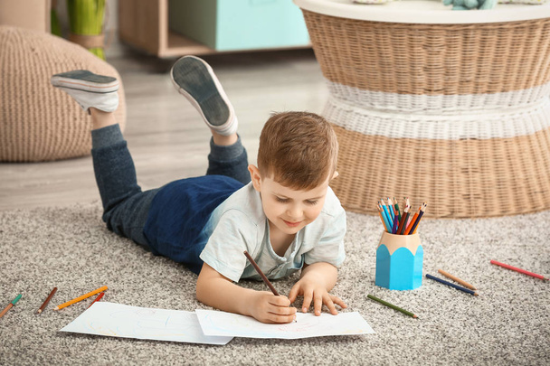 Cute little boy drawing at home - Фото, изображение
