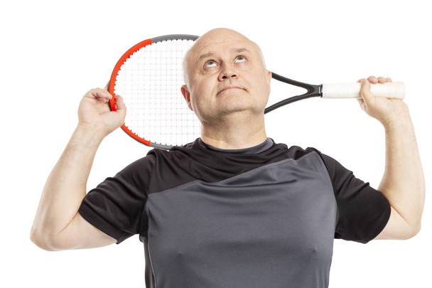 Adult bald man in sportswear with a tennis racket in his hand. Isolated on a white background.  - Valokuva, kuva