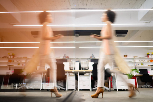 Professional business woman in motion with blur in business coworking office - Photo, image