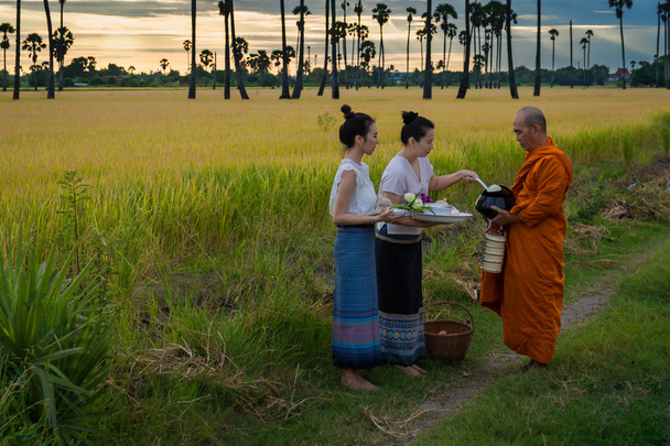 Women make merit with monk in rural areas according to the beliefs of Buddhism in Thailand - Photo, image