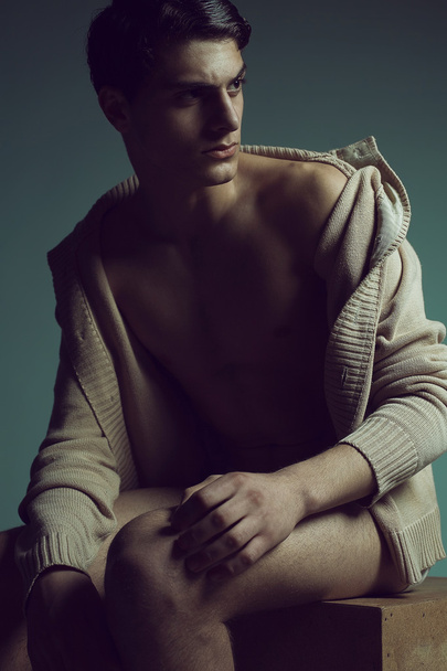 Male high fashion concept. Portrait of a handsome male model sit - Foto, afbeelding