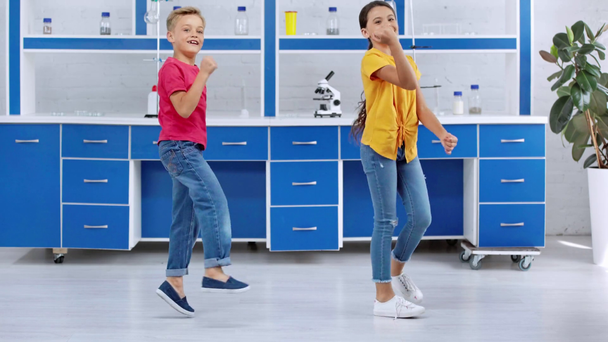 happy children dancing in laboratory  - Footage, Video