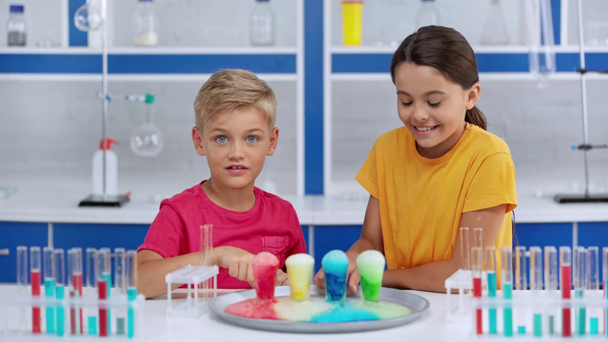 selective focus of kids adding water in colorful liquids  - Footage, Video