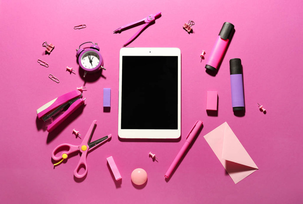 Different school stationery and tablet computer on color background - Foto, immagini