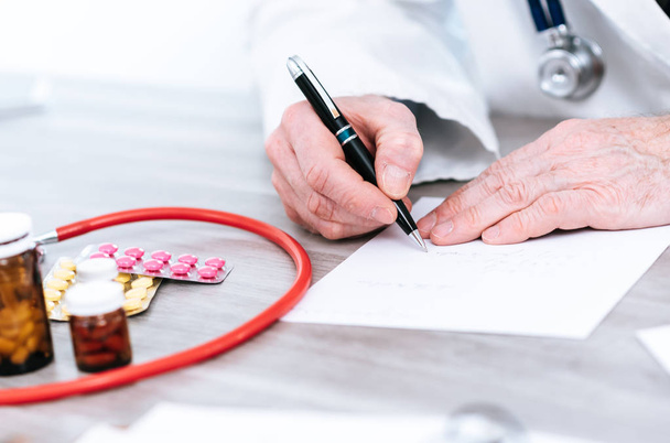 Doctor writing a medical prescription - Photo, Image