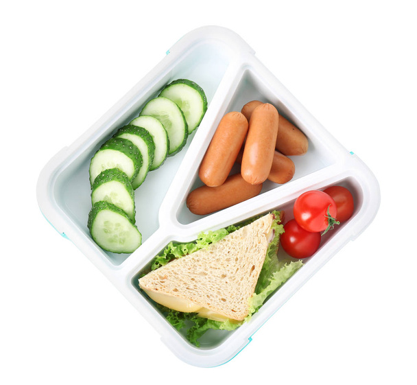 Lunchbox met lekker eten op witte achtergrond - Foto, afbeelding
