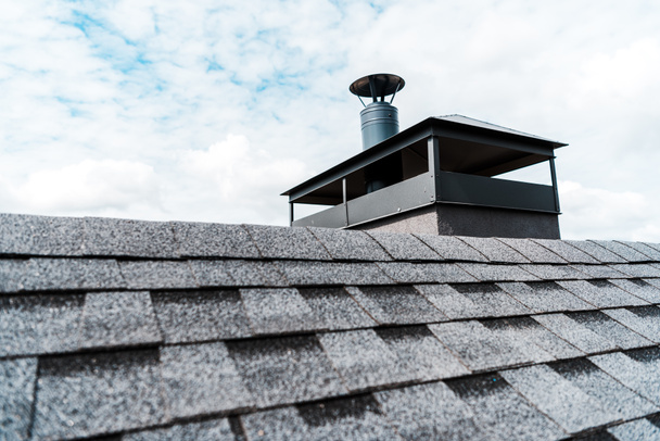 selective focus of modern chimney on rooftop of house  - Photo, Image