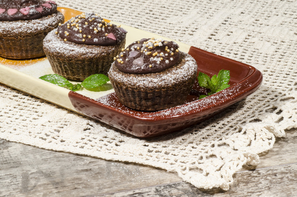 Diet chocolate cupcakes on yeliow rectangular plate - Photo, image