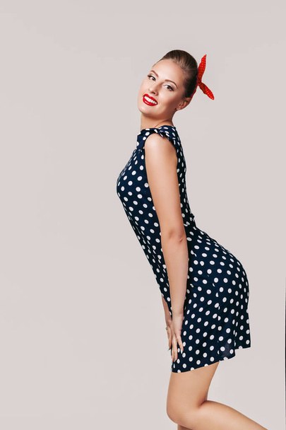 pin up woman in polka dot dress. - 写真・画像