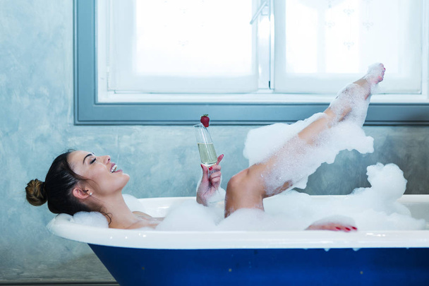 Веселая женщина с шампанским в ванной
 - Фото, изображение
