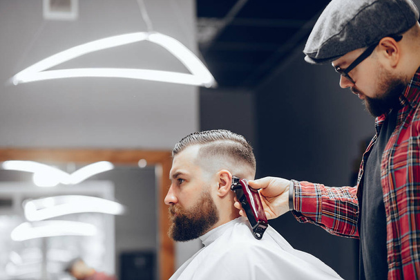 Stylish man sitting in a barbershop - Фото, зображення