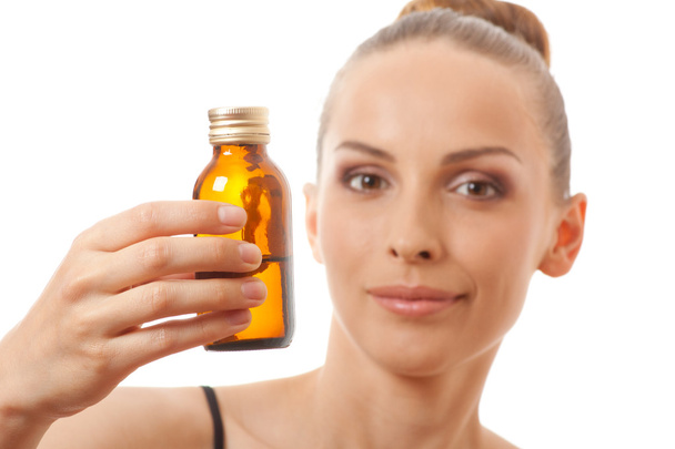 Young woman holding a bottle of medicine - Photo, Image