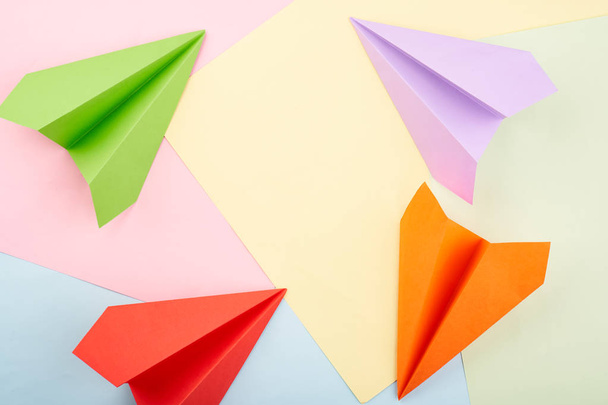 Circle of origami color paper planes on the color background - Fotó, kép
