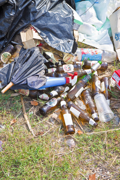 Illegal dumping with bottles, boxes and plastic bags abandoned i - Photo, Image