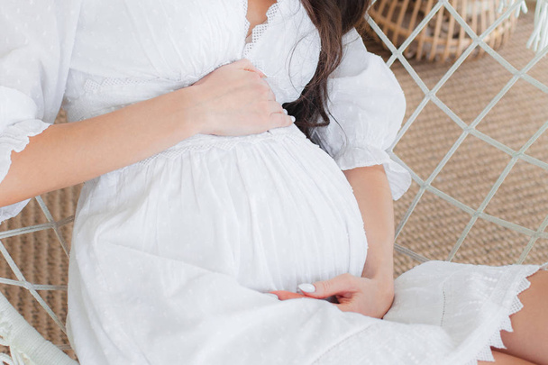 Young beautiful pregnant woman in white dress - Φωτογραφία, εικόνα