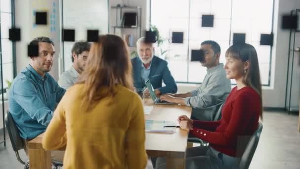 In the Meeting Room Young and Beautiful Female Junior Associate Reports to Company's Specialists, Managers and CEO who are Sitting at the Conference Table Listening. Everybody Applauds Her Success - Video