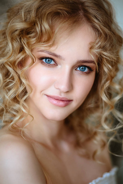 Close up portrait of blonde charming young woman with curly hair and natural makeup. Sunny morning, spa and care - Photo, image