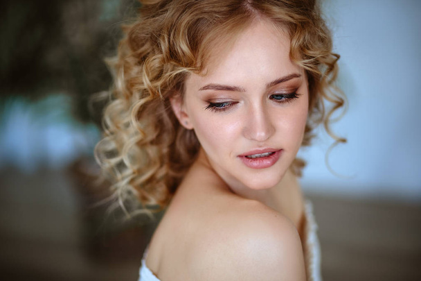 Close up portrait of blonde charming young woman with curly hair and natural makeup. Sunny morning, spa and care - Fotó, kép