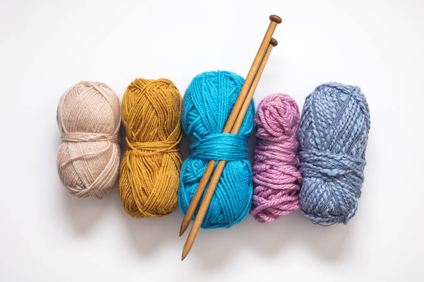 Knitting background. Balls of wool and knitting needles on a pla - Fotó, kép