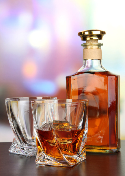 Glass of whiskey with bottle, on dark background - Фото, зображення
