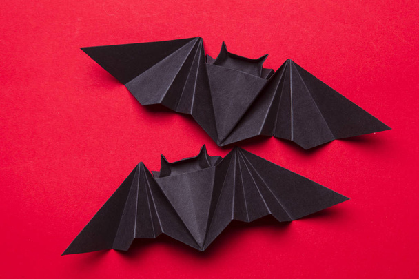 Halloween bats made from paper on a red background - Foto, imagen