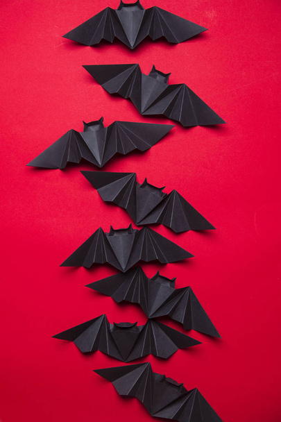 Halloween bats made from paper on a red background - Foto, Imagen