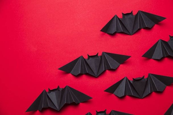 Halloween bats made from paper on a red background - Foto, immagini