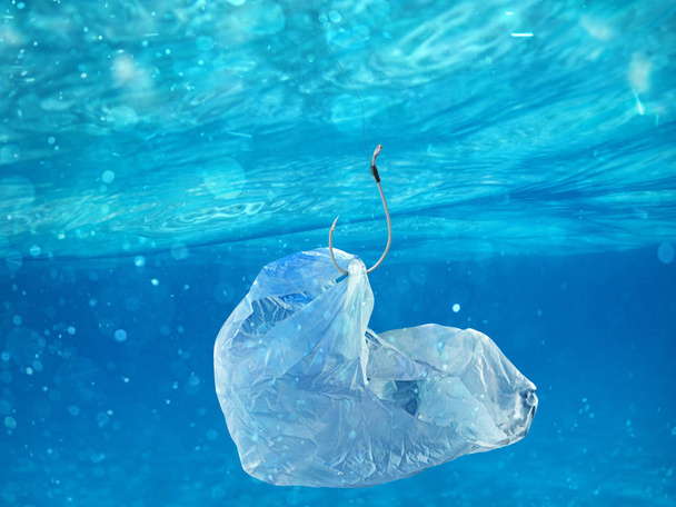 Floating bag. Problem of plastic pollution under the sea concept. - Foto, afbeelding
