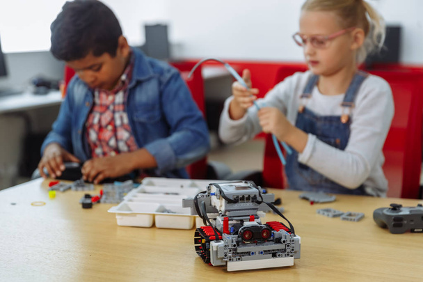 Mixed Racial group of School kids sitting at class with diy robot, stem education concept. - 写真・画像