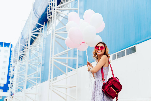 Happy girl standing with air balloons, outside. - Foto, Imagem