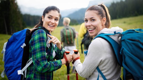Friends hiking together outdoors exploring the wilderness and having fun - Photo, Image