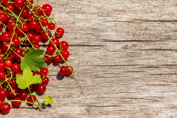 Red currant berries on rustic wooden background. Top view, copy space - Φωτογραφία, εικόνα