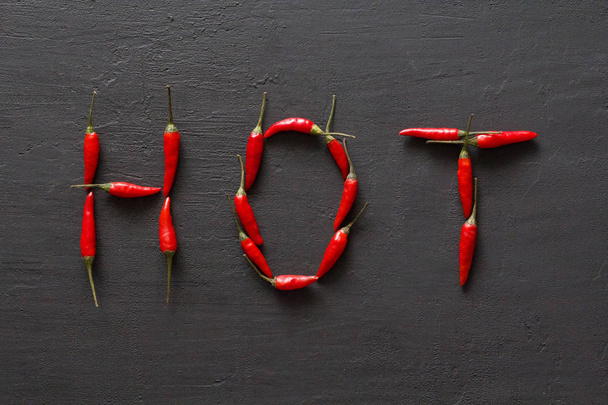 Word Hot Red Hot Chili Peppers On Black Dark Background on Black - Фото, зображення