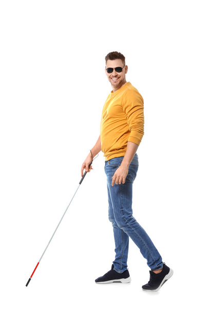 Blind man in dark glasses with walking cane on white background - Photo, image