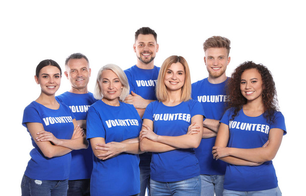 Team of volunteers in uniform on white background - Foto, imagen