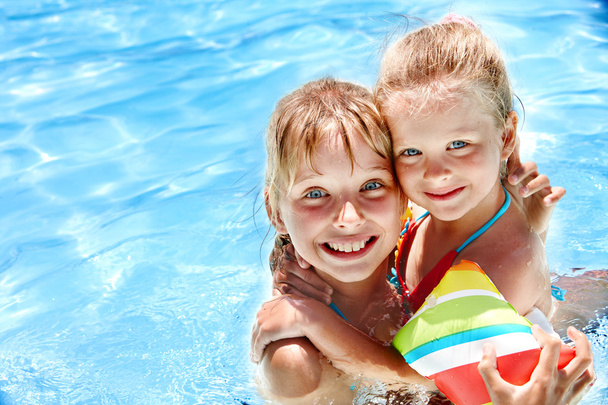 Kids with armbands in swimming pool. - Photo, Image