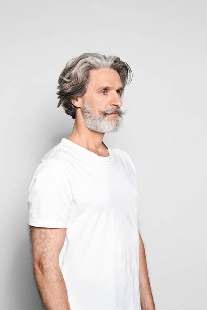 Portrait of charming mature man on light grey background - Фото, изображение