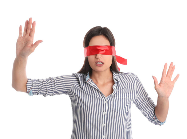 Young woman wearing red blindfold on white background - Photo, Image