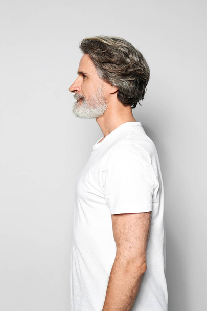 Portrait of charming mature man on light grey background - Foto, afbeelding
