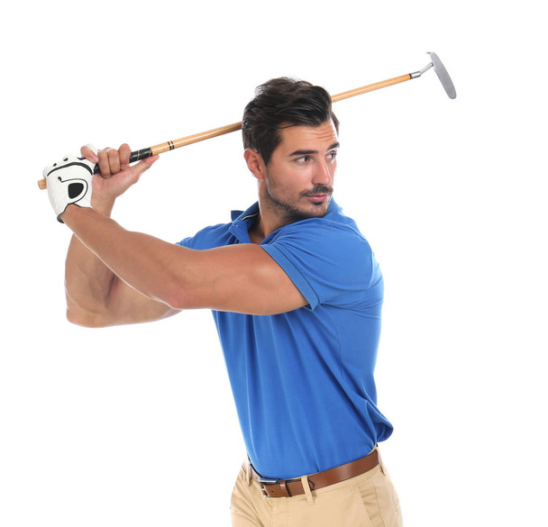 Young man playing golf on white background - Valokuva, kuva