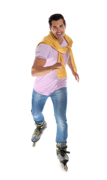 Handsome young man with inline roller skates on white background - Foto, imagen