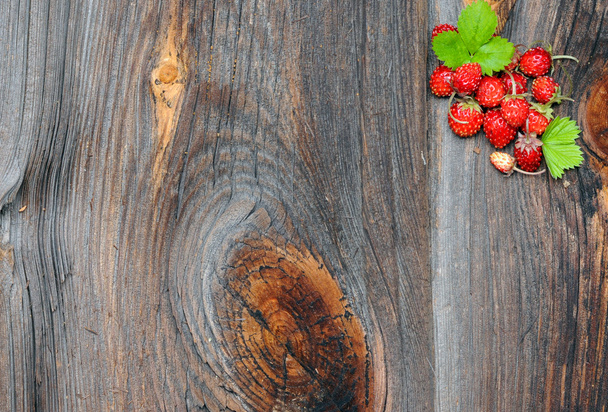 Wild strawberries on wooden background - Photo, Image