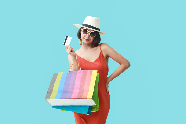 Portrait of asian girl wearing dress and sunglasses holding shop - Photo, Image