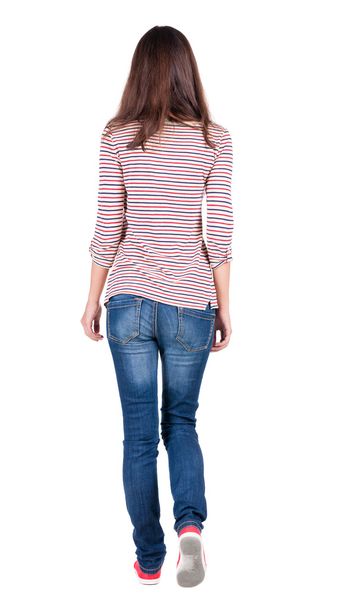 back view of walking woman in jeans . - Фото, изображение