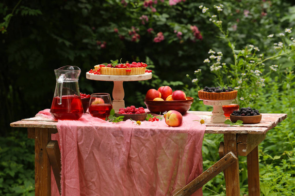 piknik luonnossa, piirakoita ja salaatteja, tuoreita marjoja ja hedelmiä
 - Valokuva, kuva