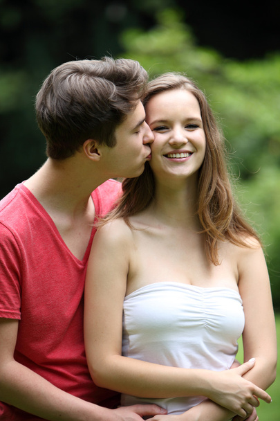 Loving young man kissing his girlfriend - Fotó, kép