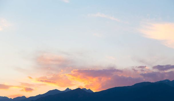 soft sunset sky. pink and gold clouds. High mountains. Natural background. - Photo, Image