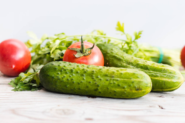Fresh tomatos and cucumbers on wooden background - Zdjęcie, obraz